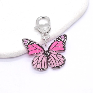 Detailed macro view of pink gradient butterfly keychain with heart shaped clasp and glitters