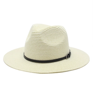 Detail of cream straw Panama hat featuring a black leather band and silver metal buckle