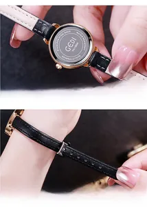 Detailed macro view of the stainless steel back case and black leather strap with stitching