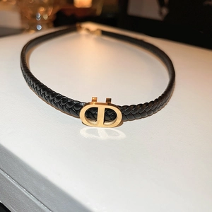 Minimalist black faux leather choker necklace with gold metal CD charm in a sleek design