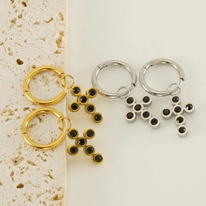 Detail of 18k gold and silver stainless steel cross hoop earrings with black zircon stones