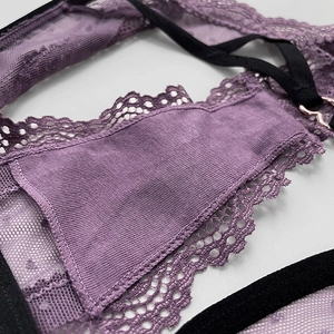 Purple lace thong for women featuring black elastic straps and a gold heart-shaped buckle
