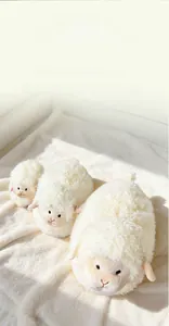 Trio of cute fluffy white sheep plush toys in three sizes on a soft textured background
