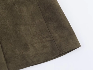 Detailed macro view of high-quality dark brown suede fabric texture and professional stitching