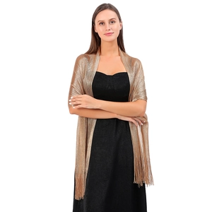 Detailed texture of champagne gold metallic shawl with elegant fringe for evening wear