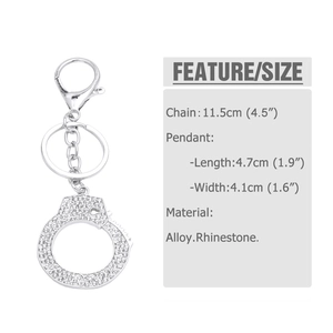 Macro view of silver handcuff keychain pendant encrusted with sparkling rhinestones