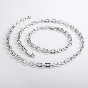 Minimalist silver stainless steel O-chain necklace and bracelet jewelry set on grey background