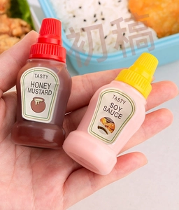 Mini sauce bottles for bento showing honey mustard and soy sauce dispensers in hand