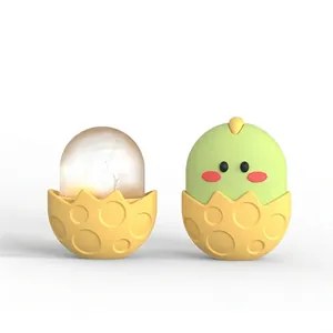 Macro detail of cartoon egg-shaped silicone face ice roller with textured base and lid
