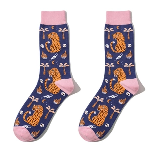 Detail of navy blue cotton socks with leopard print, pink heel and toe, palm tree pattern