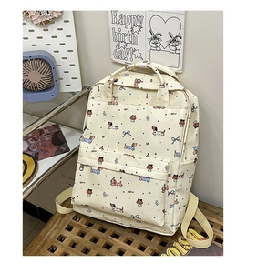 Detail of cream canvas backpack with cartoon dachshund and bow patterns in a lifestyle setting