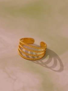 Macro shot of gold-plated multi-layer open ring featuring beaded texture details