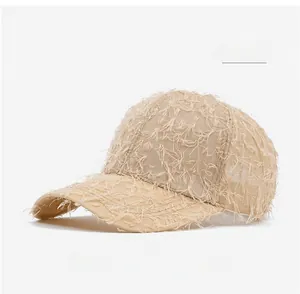 Close-up of khaki baseball cap featuring unique frayed fringe texture and distressed style