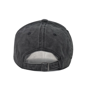 Detail of adjustable metal buckle and washed denim texture on black baseball cap