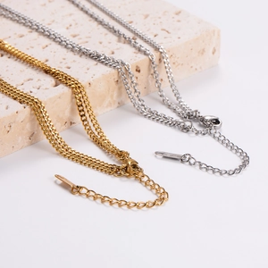 Chic fan pendant necklace in gold and silver finish on stone display base