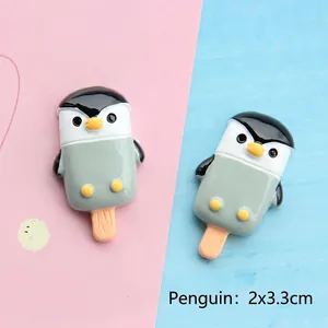 Detailed macro view of 2x3.3cm resin penguin popsicle charms for DIY phone case making