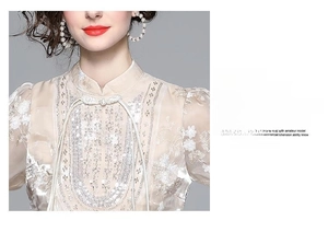 Detail of champagne Chinese top featuring heavy floral embroidery and sequin embellishments