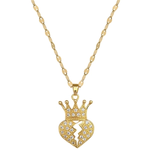 Elegant gold crown and broken heart necklace with sparkling zircons on white background