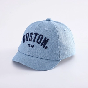 Close-up of Boston embroidery and texture on light blue denim toddler baseball cap