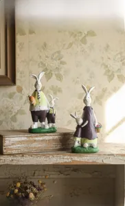 Detail of vintage hand-painted resin rabbit family figurines with pastoral home decor