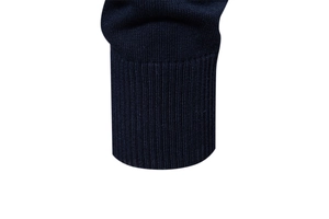 Macro detail of navy blue ribbed cuffs on a high-quality men's knitted sweater