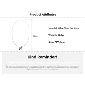 Detailed close-up of tiger eye stone pendant and owl leaf accents on a 72cm long tassel necklace