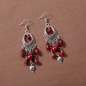 Bohemian silver earrings with red beads and hollow oval charms in vintage ethnic style