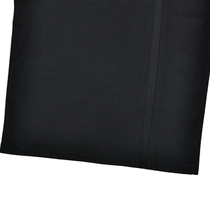 Close-up of black fabric texture with double stitching on the evening dress hem