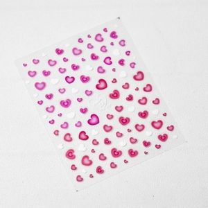 Self-adhesive nail art stickers featuring multi-colored heart patterns on white background
