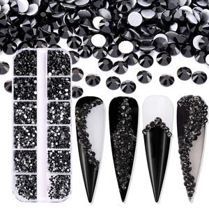 Close-up of black flatback rhinestones in a 12-grid box and nail art display effects