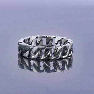 Macro view of vintage Cuban link chain ring in stainless steel with mirror reflection