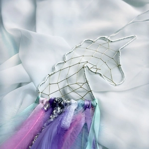 Unicorn dream catcher wall decor with colorful feathers and ribbons for kids room