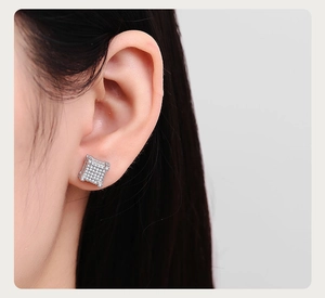 Close-up of square iced-out stud earrings with silver plating and micro-pave zircons