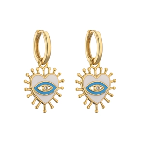 Macro shot of gold heart earrings featuring blue enamel evil eye and zircon inlay