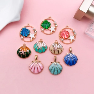 Detail of colorful enamel shell and starfish charms with gold finish for DIY jewelry