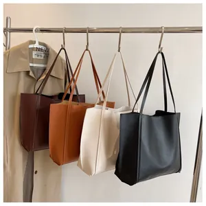 Row of four high-capacity tote bags in burgundy, caramel, cream, and black colors