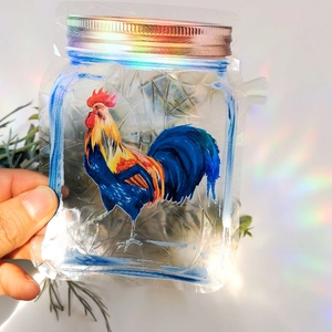 Holographic suncatcher sticker in a jar shape featuring a colorful rooster pattern