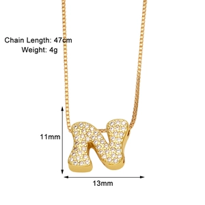 Detailed view of gold N initial pendant with zircon inlay and product dimensions