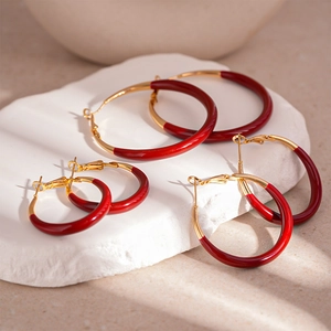Three pairs of vintage dark red enamel hoop earrings in small, medium, and large sizes