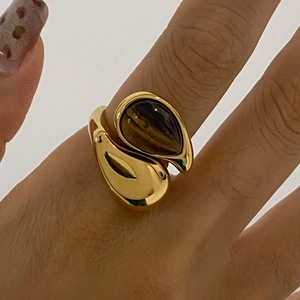 Anello in acciaio inossidabile dorato con pietra occhio di tigre a goccia sulla mano