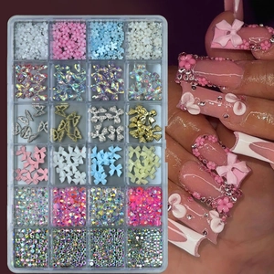 24-grid nail art set featuring 3D resin flowers, butterflies, pearls, and colorful rhinestones