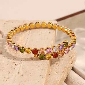 Detail of 18K gold-plated stainless steel bracelet with colorful round zirconia stones