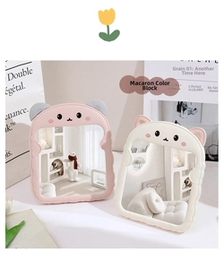 Detail of cute bear-eared foldable desktop mirrors with pastel pink and cream wave frames