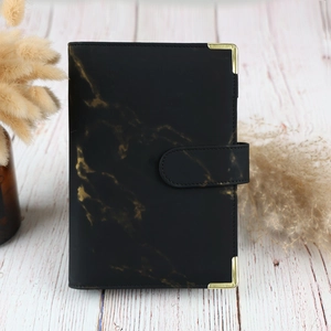 Detailed view of A6 black marble PU leather binder cover with golden metal corners