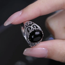 Dettaglio di un anello in argento S925 con una grande pietra nera ovale e motivi traforati