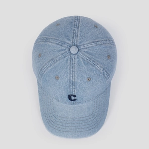 Detail of light blue denim baseball cap with navy blue embroidered C letter and stitching