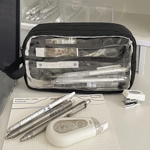 Detail view of a large-capacity black nylon mesh pencil case with transparent window