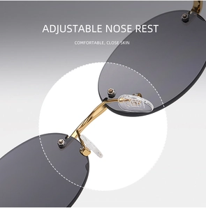 Detail of adjustable silicone nose pads and gold metal bridge on rimless sunglasses
