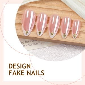 French tip press-on nails with pink cat-eye texture and golden starburst accents