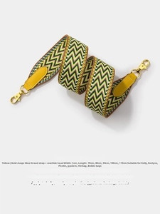 Close-up of 5cm wide yellow herringbone woven strap with leather ends and gold hardware